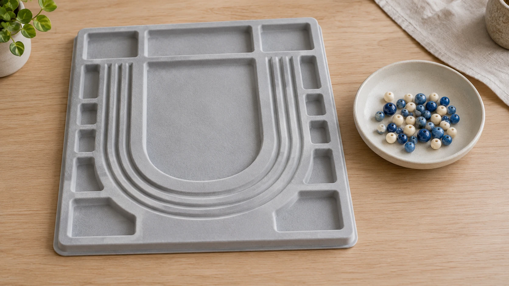 How to plan a bead pattern concept with a whole generic empty bead board and separate loose beads on a craft table.