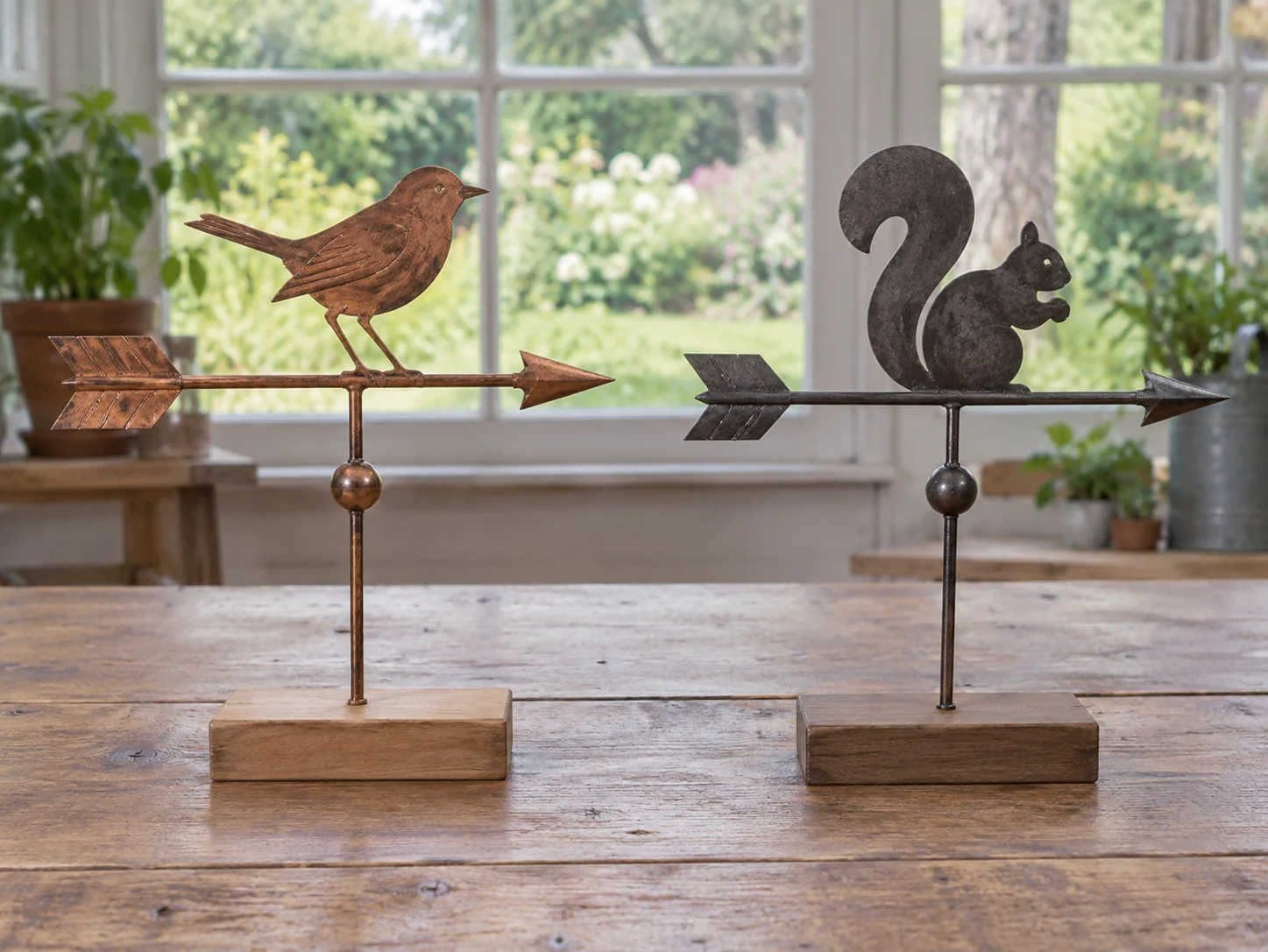 Wind-vane direction concept with two whole generic inactive decorative arrow vanes on display bases; no exact models, compass reference or wind reading shown.